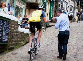 Handing out a chocolate sample to a cyclist ahead of the Tour de France in 2014